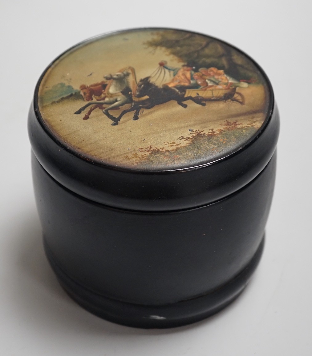 An early 20th century Russian lacquer tobacco box, the cover painted with a winter scene with figures in a troika. 9.5cm high